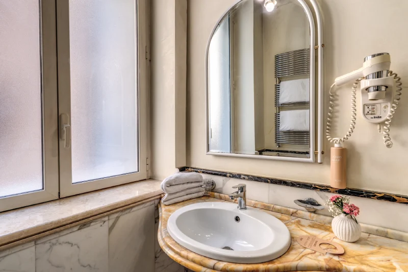 Bathroom with marble sink, mirror and hairdryer in elegant setting near Rome Opera House - Depandance Opera, BZAR hotels in Rome