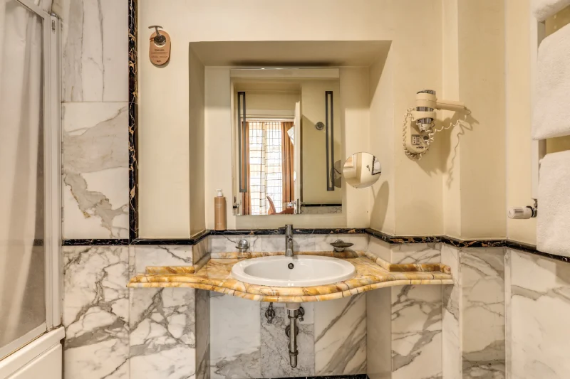 Private bathroom with marble sink, large recessed mirror and hairdryer near Rome Opera House - Depandance Opera, BZAR hotels in Rome