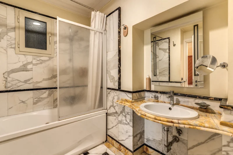 Bathroom with shower bathtub, marble wall finishes and stone sink, bright space near Rome Opera House - Depandance Opera, BZAR hotels in Rome