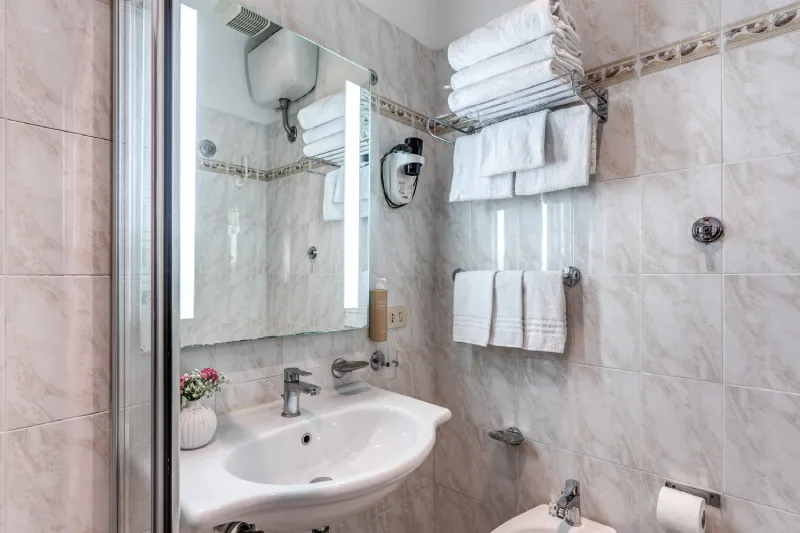 Private bathroom with sink, illuminated mirror and towels, modern comfort in Rome centre near Teatro dell’Opera - Hotel Sonya, BZAR hotels in Rome